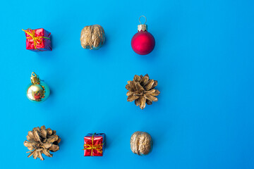 Christmas composition. Gifts, pine cones, Christmas tree decorations on a blue background. Christmas, winter, new year concept. Flat lay, top view, copy space