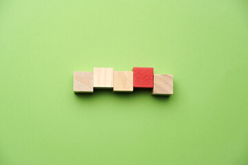 A wooden cube on green backgroud, business, finance and education concept