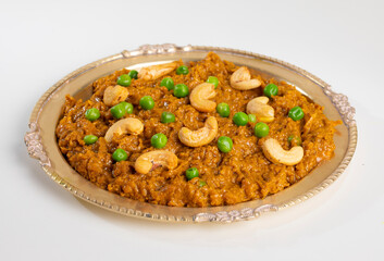 Rajasthani Famous Traditional Cuisine Haldi Sabji or Tukkar Served with Salad on White Background