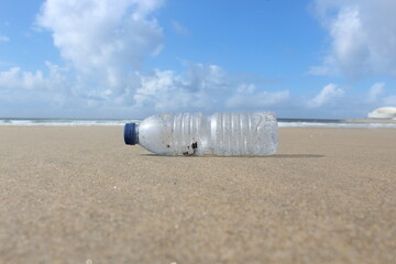 Global warming. Plastic bottle pollution on the beach. Nature protection. 