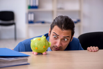 Young male employee in budget planning concept