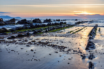 Barrika wild beach at sunset, Biscay, Basque Country, Spain.