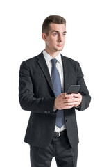 Serious young businessman using smartphone, isolated