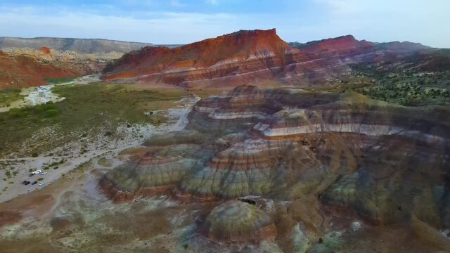 Cinematic aerial flyover of colorful sandstone strata at sunset in Southern  Utah
