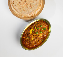 Rajasthani Famous Traditional Cuisine Haldi Sabji or Tukkar Served with Salad on White Background