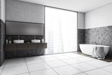 Grey and white bathroom with white bathtub, mirror and big window