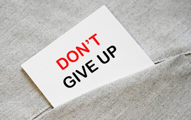 Motivational phrase, don't give up, wtitten on white sticker in the shirt pocket