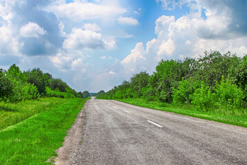 Long country road with white lines in the centre