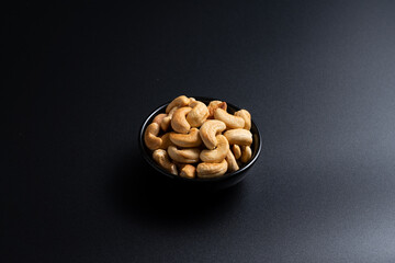 Cashew nut in container with black background