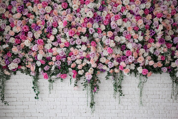 white brick wall with beautiful flowers in the room