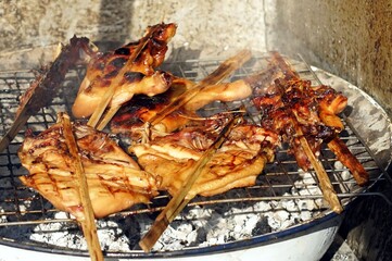 A roast chicken on the grill stations.
