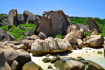 Fototapeta na wymiar Anse Marron beach with big granite boulders on La Digue Island, Seychelles. Tropical landscape with sunny sky. Exotic travel destination.