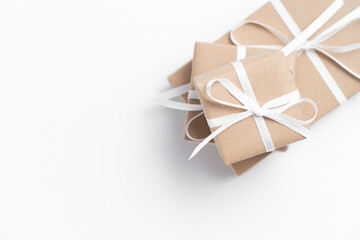 Fototapeta na wymiar Brown gift box tied with white ribbon on clear background