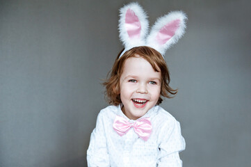 Cute little child wearing bunny ears on Easter day.