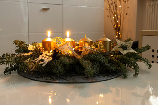 The first two candles burning on a home made advent wreath at the second advent, 3 weeks before christmas.