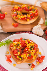 Friselle with tomatoes and mais.
