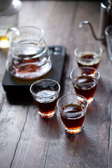 Coffee drip on the table, ground coffee beans contained in a filter. Breakfast concept.