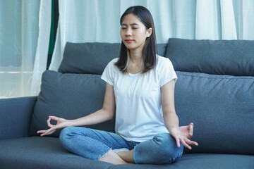Obraz premium yogi woman practicing yoga lesson, breathing, meditating, indoor close up. Well being, wellness concept