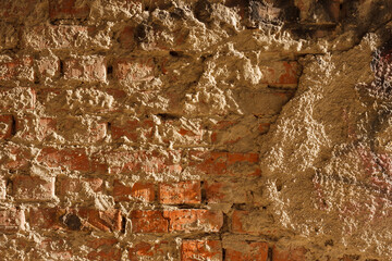 The surface of the plastered old brick wall. Texture of a brick wall with a stucco.