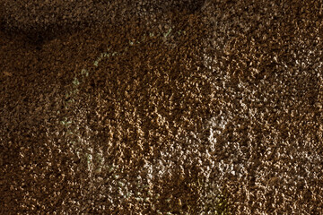 The surface of the plastered old brick wall. Texture of decorative plaster with a relief. Close-up.