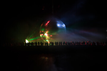 Colorful disco mirror ball lights night club background. Party lights disco ball. Selective focus