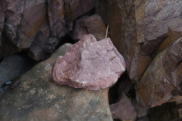 raw pink sandstone on nature background. arkosic sandstone sedimentary rocks.