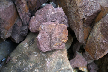 raw pink sandstone on nature background. arkosic sandstone sedimentary rocks.