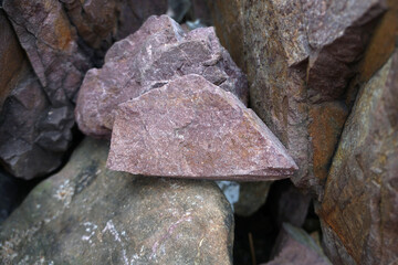 raw pink sandstone on nature background. arkosic sandstone sedimentary rocks.