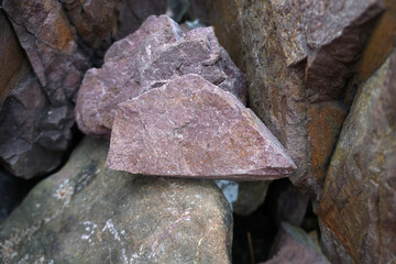 raw pink sandstone on nature background. arkosic sandstone sedimentary rocks.