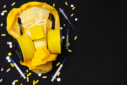 Doctors fight against coronavirus concept. Struggle of infectiologist with covid-19. Development of vaccine against coronavirus. Respirator and syringes, many pills with space for text. Copy space