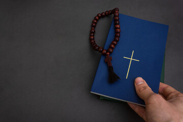 Reading Religious literature and freedom of religion. Take Bible with christian cross on cover and...