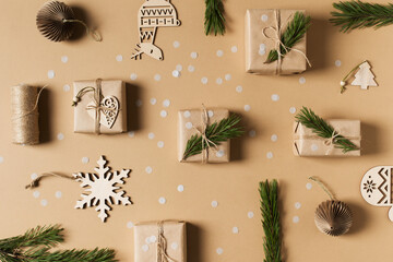 Fototapeta na wymiar Kraft paper gift box knolling flat lay on brown background, christmas, holidays and eco theme