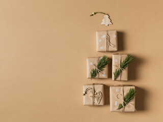 Kraft paper gift box on brown background, christmas, holidays and eco theme, christmas tree shape