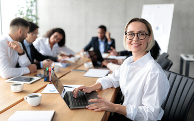 Young Businesswoman Sitting At Laptop Having Corporate Meeting In Office