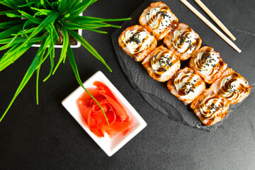 Sushi rolls with sesame seeds and topped with cream cheese