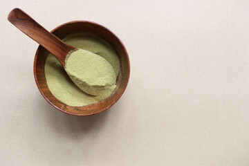 Fototapeta na wymiar Powder matcha green tea in a bowl on wooden background