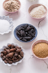 Assortment of flagrant baking ingredients on white wooden background