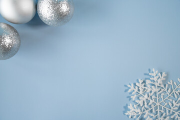 Blue christmas background with pine balls and snowflake.