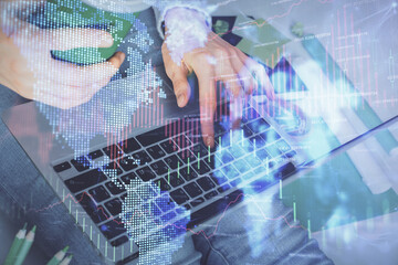 Double exposure of woman hands typing on computer and forex chart hologram drawing. Stock market invest concept.