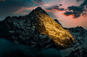 A mountain peak glowing with sunlight