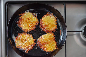 Homemade Crispy Potato Pancakes Toasted in a Vintage Cast-Iron Pan. Top View.