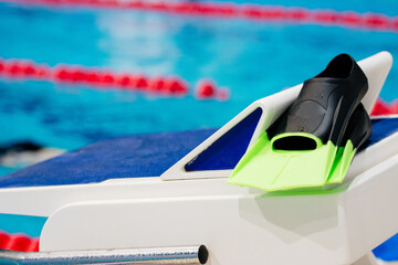 Swimming flippers on the starting platform in the swimming pool © Shamil