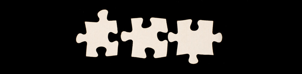 white puzzles on a black background.business concept of Solution