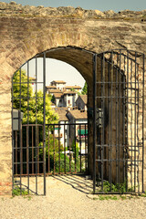 Gate of the walls of the ancient village of Asolo in summer with a view of the houses. Treviso, Italy