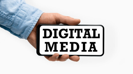 Closeup of a male hand holding Smartphone with text Digital Media on display