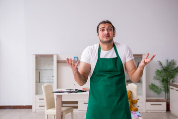 Young male contractor cleaning the flat after kids' party