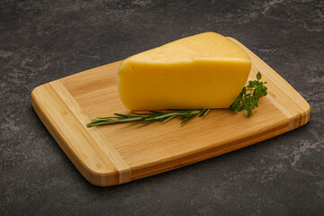 Hard cheese piece served rosemary