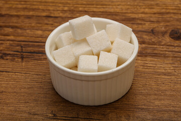 Refined white sugar cubs in the bowl