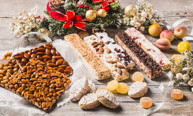 Italian Christmas sweets as different nougats with almonds, nuts, peanuts, candied fruits, marzipan...