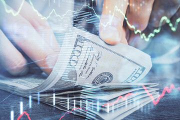 Multi exposure of forex graph drawing hologram and USA dollars bills and man hands. Technical Analysis concept.